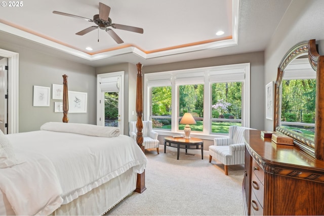 bedroom with recessed lighting, a raised ceiling, light carpet, and a ceiling fan