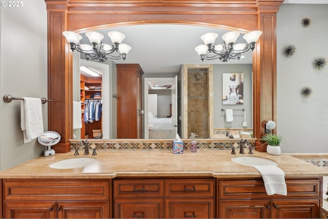 full bathroom with double vanity, a sink, and a chandelier