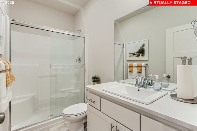 bathroom with walk in shower, vanity, and toilet