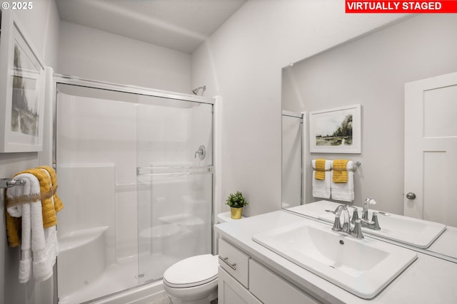 bathroom featuring vanity, toilet, and an enclosed shower