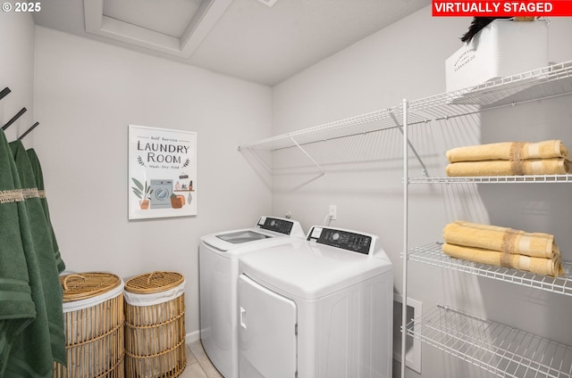 laundry area with washing machine and clothes dryer and tile patterned floors