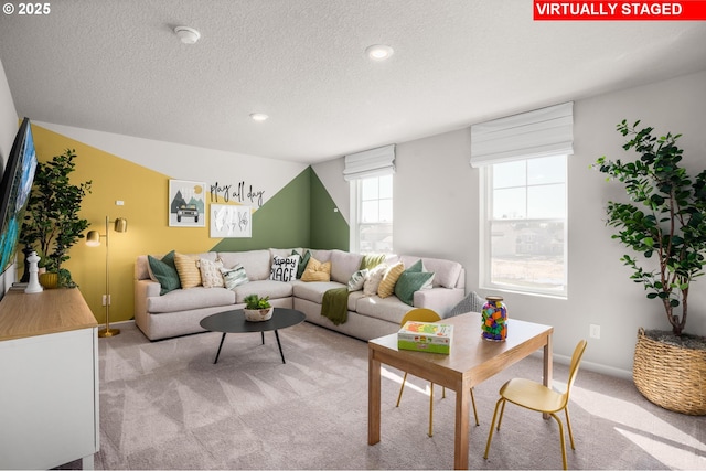 carpeted living room featuring a textured ceiling