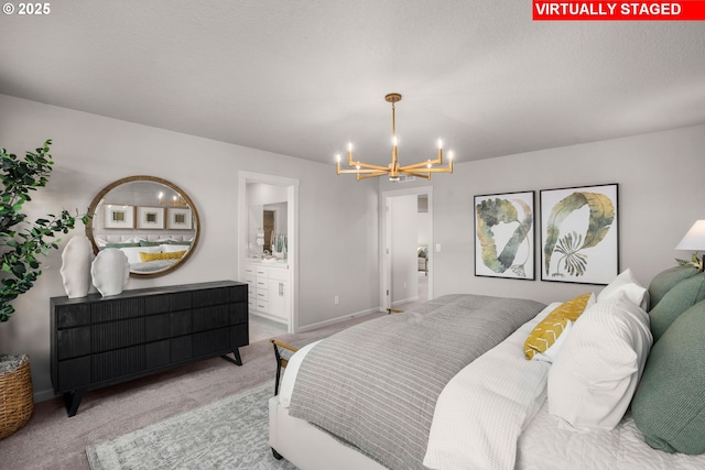 bedroom with carpet floors, connected bathroom, a textured ceiling, and a chandelier