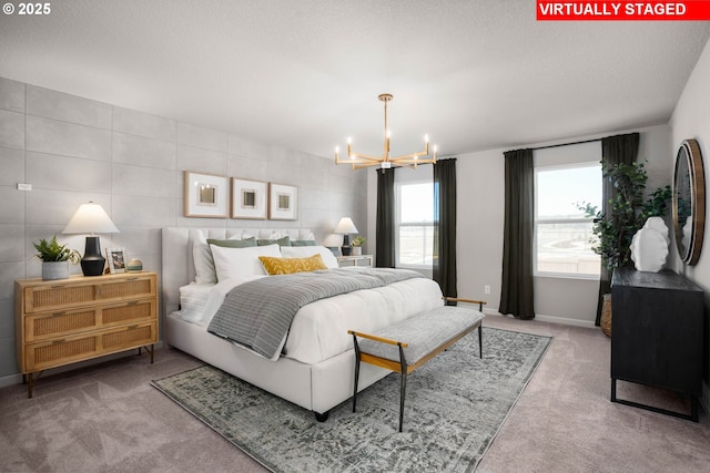 carpeted bedroom featuring an inviting chandelier and a textured ceiling