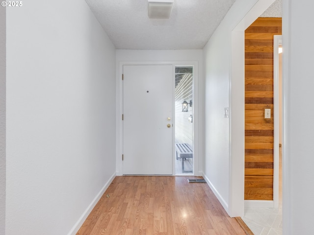 20270 SW Brightwood Ct, Beaverton, OR 97003 - hallway featuring light wood-style flooring, baseboards, and a textured ceiling