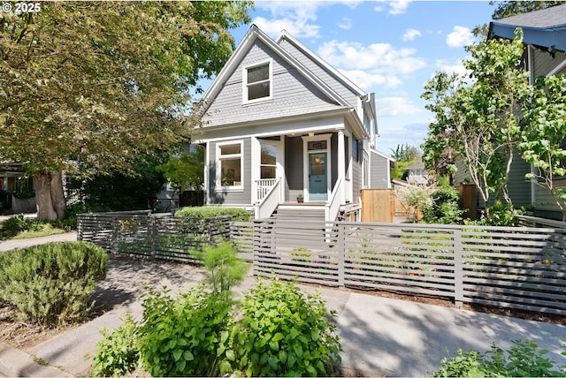 1912 NE 11th Ave, Portland, OR 97212 - victorian home with a porch, a fenced front yard, stairway, and a gate