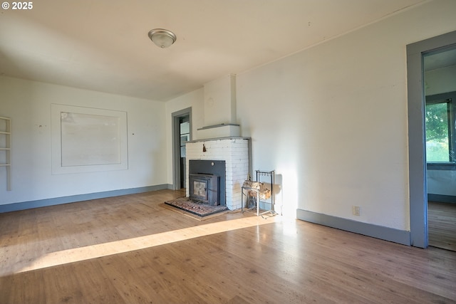 1641 Mabee Mines Rd Unit 4, Washougal, WA 98671 - unfurnished living room with wood finished floors and a brick fireplace