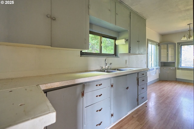 1641 Mabee Mines Rd Unit 4, Washougal, WA 98671 - kitchen with light wood-style floors, plenty of natural light, light countertops, a textured ceiling, and decorative light fixtures