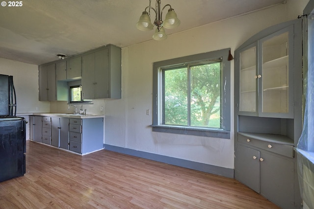 1641 Mabee Mines Rd Unit 4, Washougal, WA 98671 - kitchen with gray cabinets, a chandelier, light wood-type flooring, and light countertops