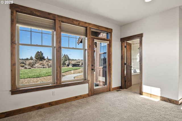 entryway with carpet flooring and baseboards