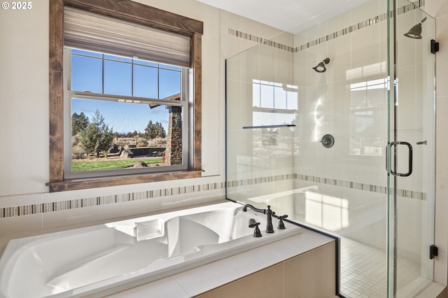bathroom featuring a bath and a stall shower
