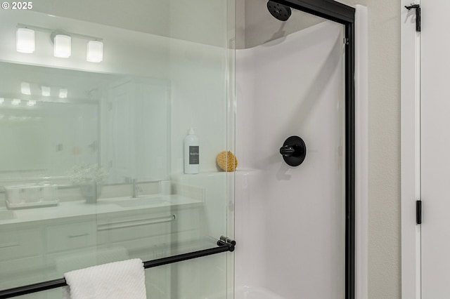 full bath with a sink and a stall shower