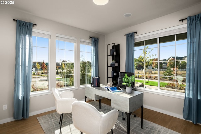 office space featuring baseboards and a healthy amount of sunlight