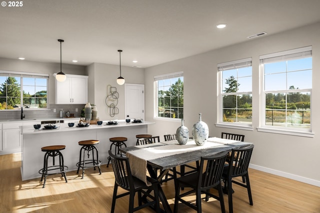 dining area with recessed lighting, baseboards, visible vents, and light wood-type flooring