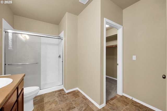 4908 Holly St, Springfield, OR 97478 - bathroom with a stall shower, vanity, a walk in closet, and stone finish floors