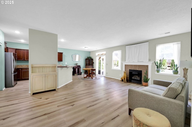 4908 Holly St, Springfield, OR 97478 - living area with light wood-type flooring, plenty of natural light, recessed lighting, and a tile fireplace