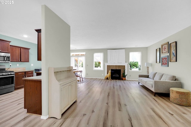 4908 Holly St, Springfield, OR 97478 - living area featuring light wood-style flooring and a tiled fireplace