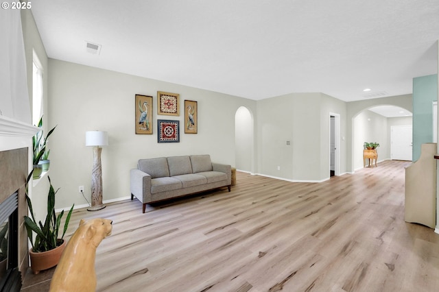4908 Holly St, Springfield, OR 97478 - living room with arched walkways, a fireplace, wood finished floors, and recessed lighting