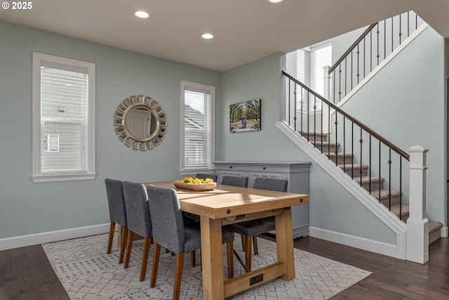 dining room with recessed lighting, baseboards, wood finished floors, and stairway