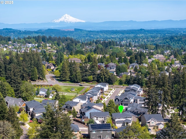 aerial view featuring a forest view, a residential view, and a mountain view
