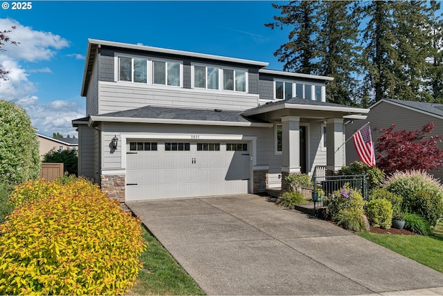 view of front of home featuring a garage, driveway, and stone siding