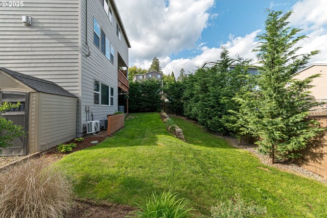 view of yard with a storage unit, ac unit, and an outbuilding
