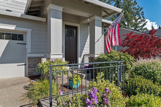 entrance to property with a garage and a porch