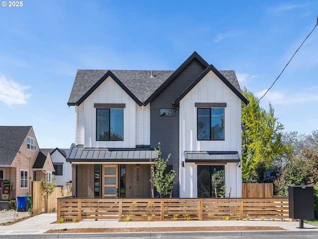 5170 SE 28th Ave, Portland, OR 97202 - modern inspired farmhouse featuring a standing seam roof, a fenced front yard, metal roof, a shingled roof, and board and batten siding