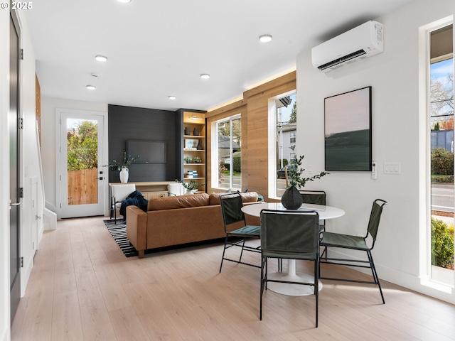 5170 SE 28th Ave, Portland, OR 97202 - dining area featuring recessed lighting, a healthy amount of sunlight, a wall mounted AC, and light wood-type flooring