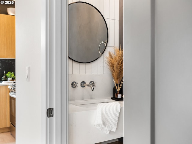 5170 SE 28th Ave, Portland, OR 97202 - bathroom featuring decorative backsplash and vanity