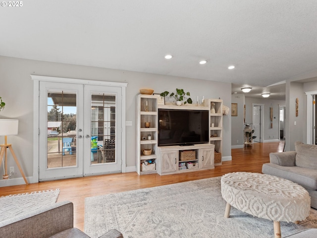 living room with french doors and hardwood / wood-style floors