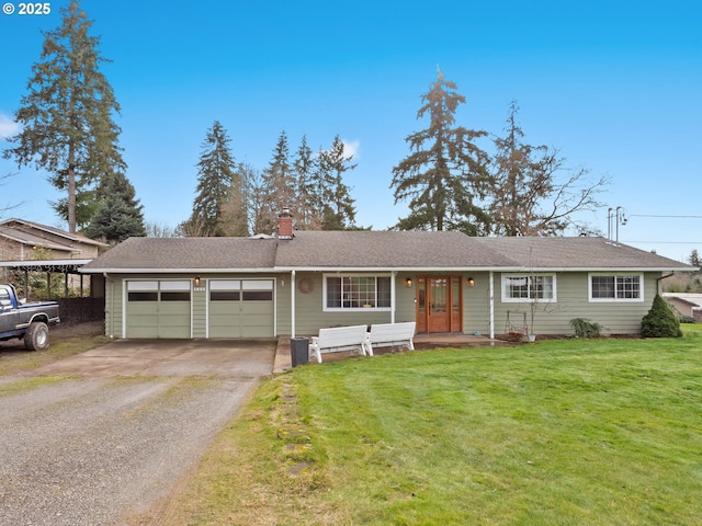 ranch-style home featuring a garage and a front lawn