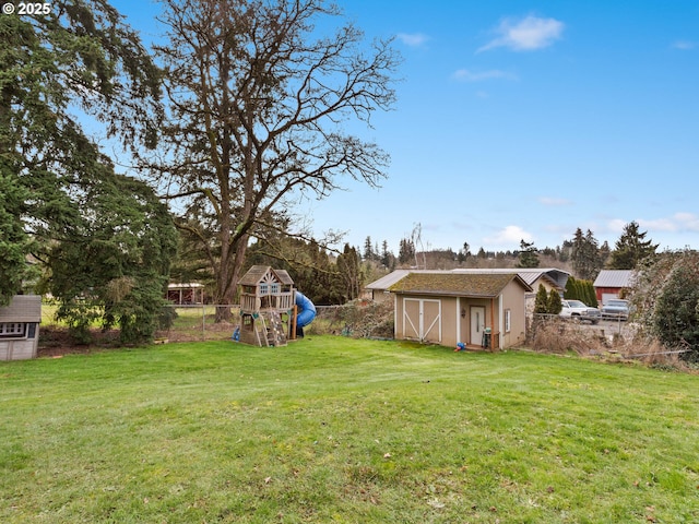 view of yard with a playground and a storage unit