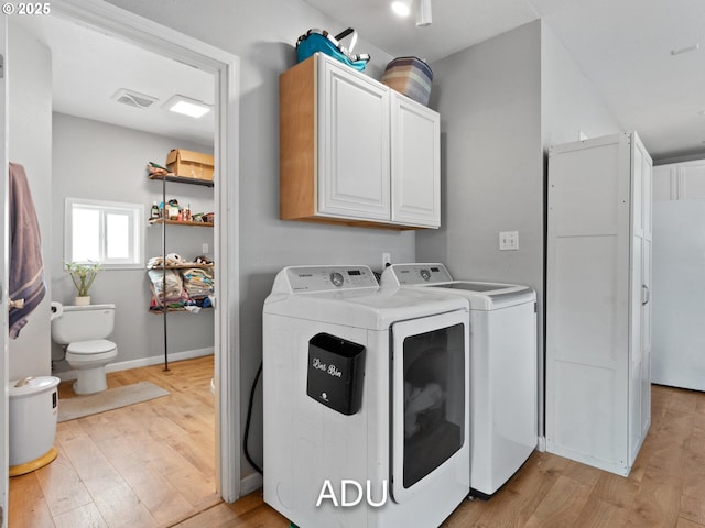 laundry area with light wood-type flooring and independent washer and dryer