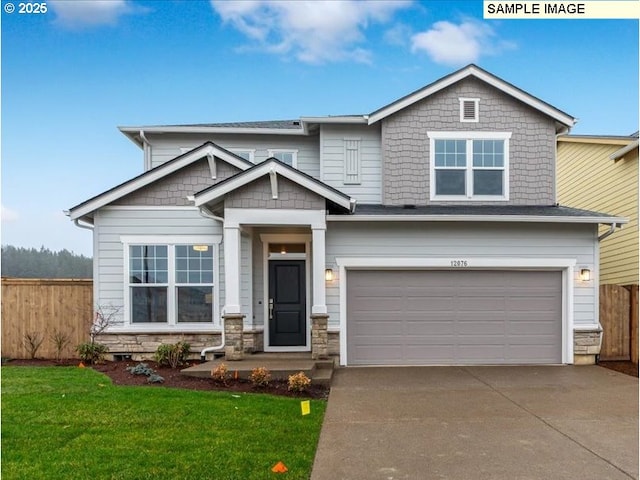 craftsman inspired home featuring a garage and a front lawn