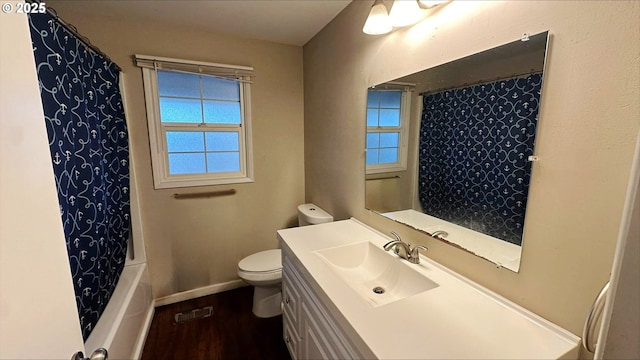 full bathroom featuring shower / bathtub combination with curtain, hardwood / wood-style floors, vanity, and toilet