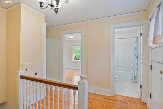 1702 24th Ave, Longview, WA 98632 - corridor with an upstairs landing, a chandelier, light wood-style flooring, and ornamental molding