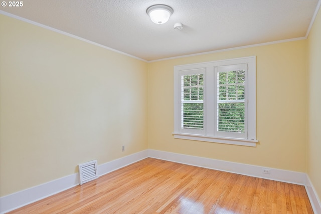 1702 24th Ave, Longview, WA 98632 - empty room featuring wood finished floors, ornamental molding, a textured ceiling, and a smoke detector