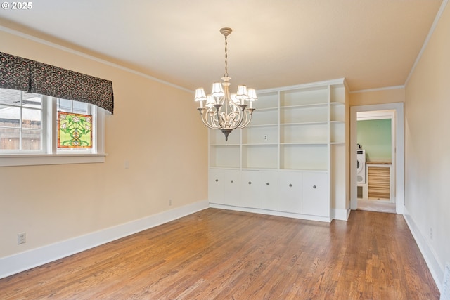 1702 24th Ave, Longview, WA 98632 - unfurnished room featuring ornamental molding, a chandelier, wood finished floors, and washer / dryer