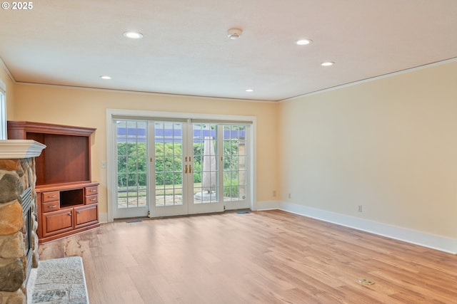 1702 24th Ave, Longview, WA 98632 - unfurnished living room featuring crown molding, light wood-style flooring, recessed lighting, and a stone fireplace