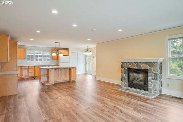 1702 24th Ave, Longview, WA 98632 - kitchen with freestanding refrigerator, light countertops, light wood-type flooring, recessed lighting, and a kitchen island