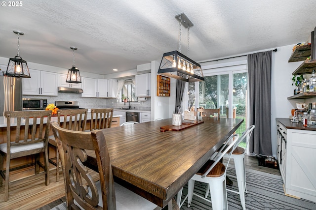 dining space with a textured ceiling