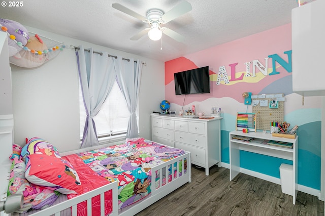 bedroom with a ceiling fan, wood finished floors, baseboards, and a textured ceiling