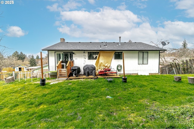 rear view of house featuring a yard, a patio, a chimney, and fence