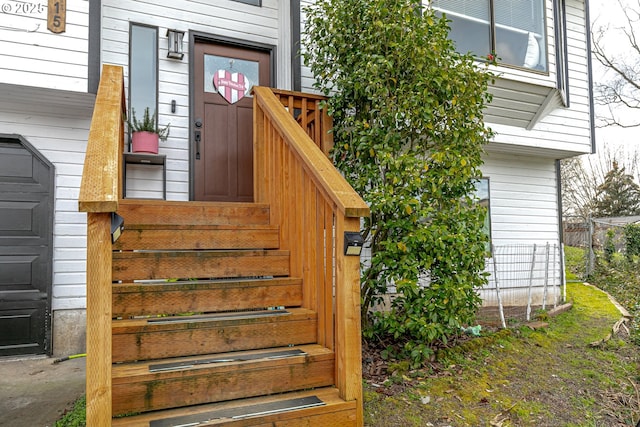 property entrance featuring a garage and fence