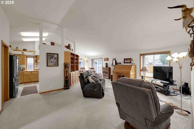 2451 Bowtie Ave, Eugene, OR 97404 - living room with a chandelier, vaulted ceiling, and light colored carpet
