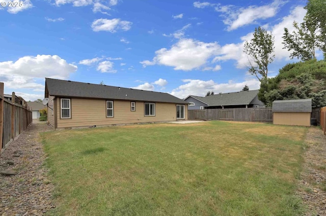 2451 Bowtie Ave, Eugene, OR 97404 - back of house with a fenced backyard, a storage unit, and a patio area