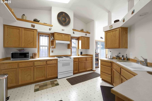 2451 Bowtie Ave, Eugene, OR 97404 - kitchen with stainless steel microwave, white gas stove, open shelves, under cabinet range hood, and light floors