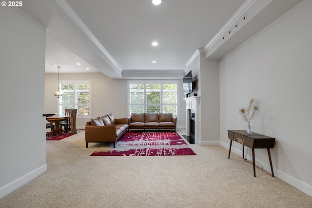 carpeted living room with ornamental molding and a chandelier