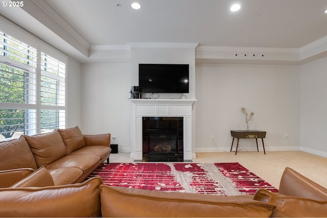 living room featuring light carpet, a tiled fireplace, and ornamental molding